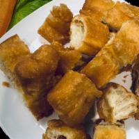 Deep Fried Dough Stick | 炸油條 · One long golden-brown deep-fried strip of dough with dipping sauce.  Also known as Chinese d...