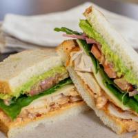 Chipotle Turkey Club Sandwich · River Bear smoked turkey, bacon, sharp cheddar cheese, chipotle ranch, avocado, pickled onio...