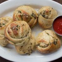 Garlic Knots · Pub favorite. Fresh bread knots tossed in garlic olive oil and dusted with a blend of spices...