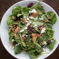 Spinach Salad · Fresh spinach, bacon, caramelized walnuts, and dried cranberries tossed in a honey dijon sau...
