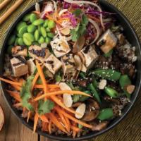 Grilled Tofu Tiger Bowl · A bed of brown rice quinoa medley topped with sugar snap peas, roasted mushrooms, edamame, s...