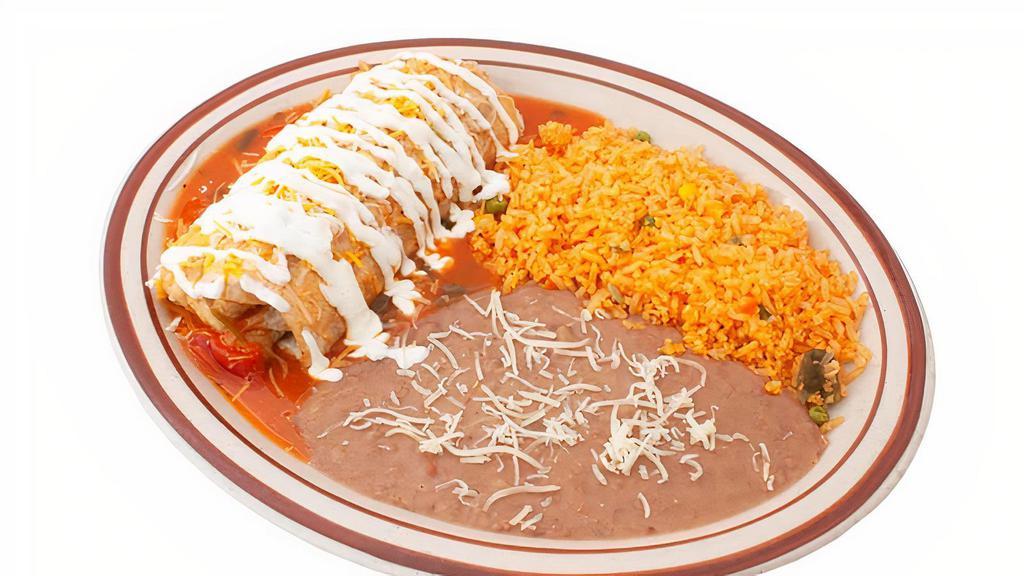 Wet Burrito · Flour tortilla filled with rice, beans, onions, cilantro, and choice of meat topped with salsa ranchera, cheese, and sour cream.