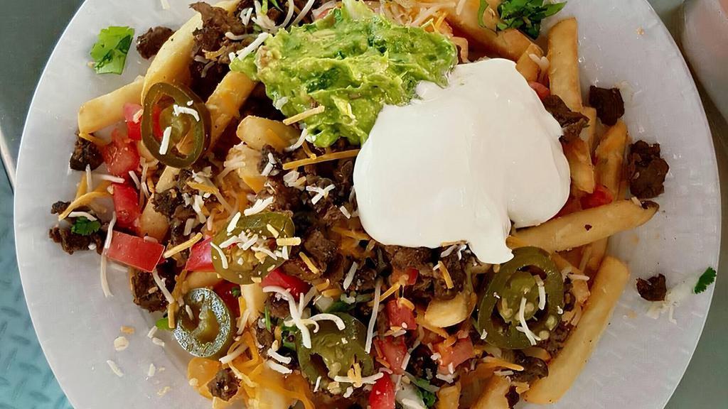 Carne Asada Fries · French fries topped with carne asada steak, cheese, pico De gallo, sour cream, guacamole, and sliced jalapeños.