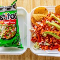 Tostilocos · Tostito chips are topped with cucumber, jicama, cueritos (pork skins), chaca chaca tamarind ...