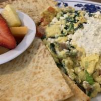 Athenian Greek Scramble · Gyro meat, Greek olives, tomatoes, spinach, green onions and Feta topped with tzatziki and s...