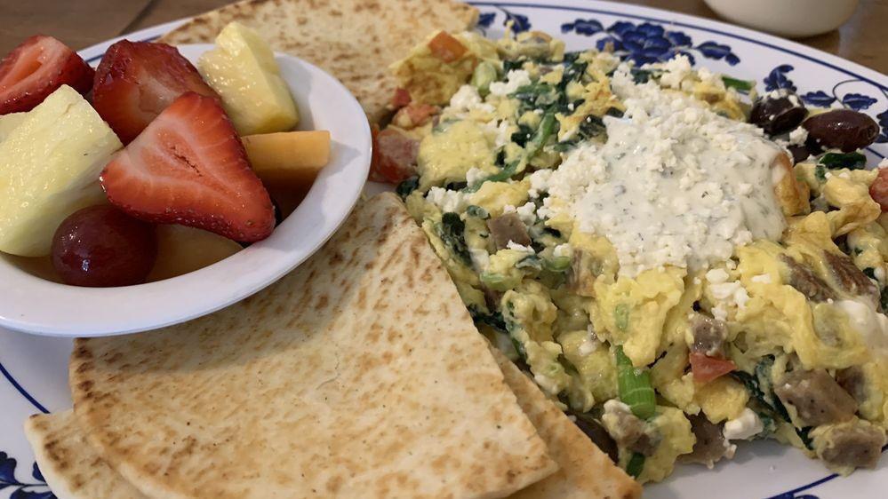 Athenian Greek Scramble · Gyro meat, Greek olives, tomatoes, spinach, green onions and Feta topped with tzatziki and served with pita. Served with hash browns and toast.
