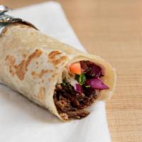Beef Shawarma Wrap · Marinated steak cut into thin slices, stacked and roasted on a vertical rotisserie. Topped w...