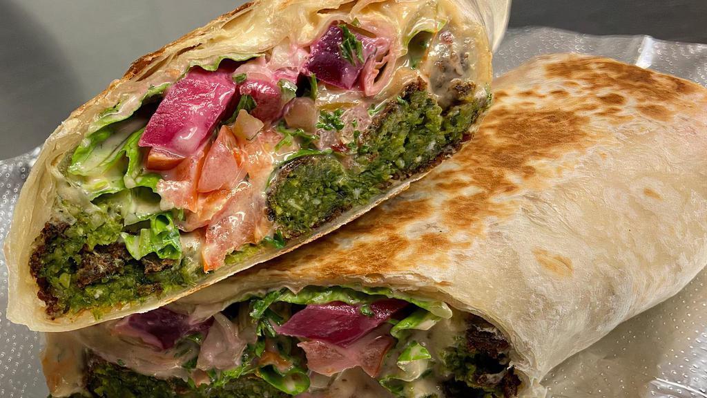 Falafel Wrap · Deep fried patties of ground Garbanzo Beans mixed with herbs, and spices. Topped with Lettuce, Tomato, Pickles, and Tahini Sauce.