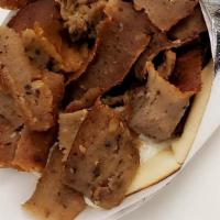 Gyros Pita · Seasoned minced beef & lamb roasted on a vertical rotisserie and sliced thin. Topped with To...