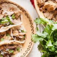 Carnitas Tacos · Gluten-free. Traditional street tacos made with fresh homemade corn tortillas. Garnished wit...
