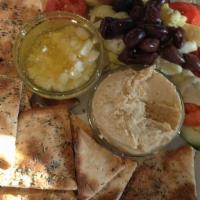Hummus Plate · Cucumbers, tomatoes, kalamata olives, artichoke hearts, feta cheese, EVOO, pita bread