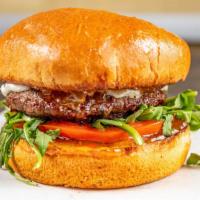 Santa Barbara Burger · fresh angus beef patty | chevre goat cheese | baby wild arugula | tomato | fig jam | brioche