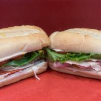 Classic Italian Sub · Thinly sliced ham, pepperoni, Genoa salami, lettuce, tomato, onion, mayonnaise, and yellow m...