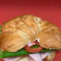 Croissant Club · Thin slices hickory smoked Turkey and Bacon on a croissant with mayo, provolone cheese, lett...
