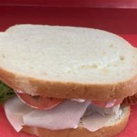 Blue Turkey Bacon · Turkey and Bacon with blue cheese , lettuce and tomato on our daily fresh baked white bread.