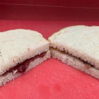Classic Peanut Butter And Jam · Peanut butter and strawberry jam on white bread.