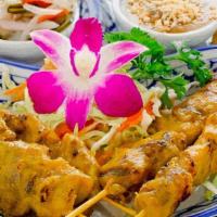 Chicken Satay · Chicken marinated in coconut milk, herbs and spices served with peanut sauce, toast and cucu...