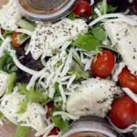 Caprese Salad · Cherry tomatoes, fresh mozzarella, sherred mozzarella, basil. Balsamic on the side.