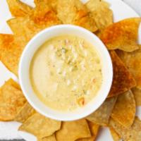 Chile Con Queso Dip · Delicious combination of two types of cheese, blended with Anaheim and jalapeño peppers, tom...