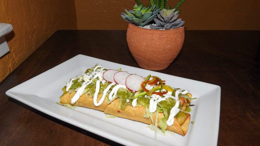 Flautas · Two rolled fresh corn tortilla stuffed with shredded beef or chicken deep fried to golden brown served with rice and refried beans along with sour cream and guacamole.