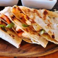 The Shrimp Quesadilla · Grilled flour tortilla filled with melted cheese, fresh shrimp, sour cream, and guacamole.