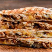 The Carnitas Quesadilla · Grilled flour tortilla filled with melted cheese, flavorful carnitas (pork), sour cream, and...