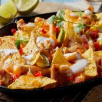 Chicken Nachos · Shredded chicken, beans, pico de gallo, guacamole, sour cream, and creamy cheese on a bed of...