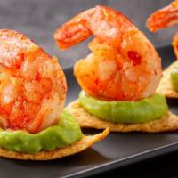 Shrimp Nachos · Fresh shrimp, beans, pico de gallo, guacamole, sour cream, and creamy cheese on a bed of hom...