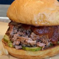 Chopped Brisket Sandwich · chopped brisket tossed in bbq sauce with house pickles. served on a potato bun with your cho...