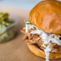 Pulled Pork Sandwich  · carolina style pulled pork and ginger coleslaw on a potato bun served with your choice of si...