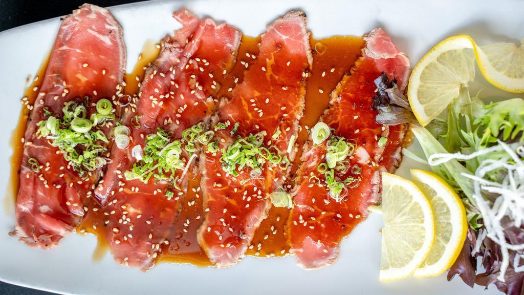 Beef Carpaccio · Hot. Thinly sliced new York strip and served with a spicy wasabi citrus sauce.