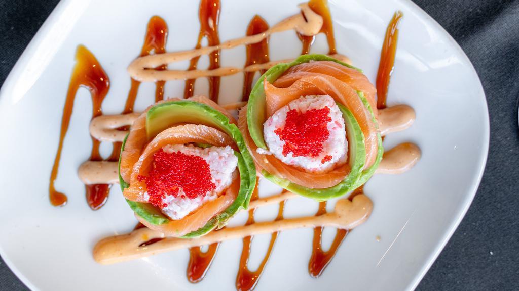 Cherry Blossom · Hot. 2pcs crab, avocado and tobiko wrapped in fresh salmon and a tangy, spicy sauce.