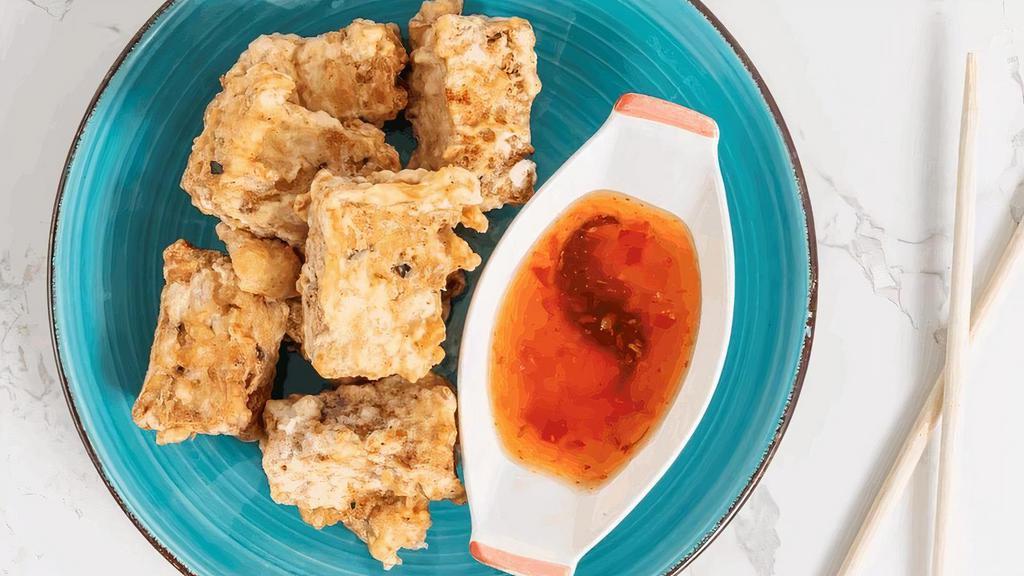 Tofu Tempura · Firm tofu deep fried to a golden brown. Served with sweet & sour sauce with ground peanut.