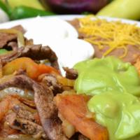 #5. Fajitas (Steak Or Chicken) · Choice of Meat - Steak or Chicken, Bell Peppers, Onion, Tomato, Guacamole and Sour Cream. Ri...