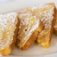 Sourdough French Toast · Golden brown, light and fluffy. Dusted with powdered sugar. Served with whipped butter and p...