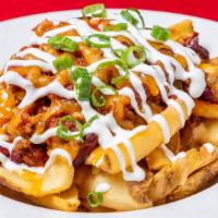 Oasis Fries · Potato  scoops, cheese sauce, chili, sour cream, topped with green onions.