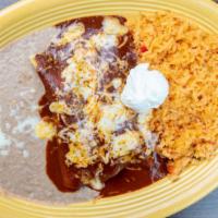 Enchiladas En Mole · Two corn tortillas filled with chicken, beef or cheese. Topped with homemade mole sauce and ...