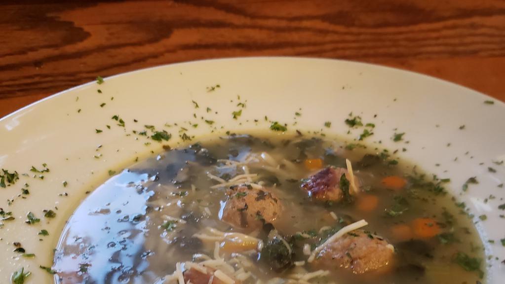 Italian Wedding Soup · Meatballs, orzo, spinach, onions, celery & carrots in a chicken broth finished with Parmesan and parsley