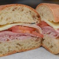 Italian Hero Sandwich · Prosciutto, Genoa salami, black forest ham, provolone cheese, tomato, onion, olive oil and r...