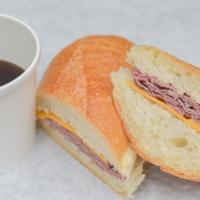French Dip Sandwich · Hot roasted beef and melted cheddar cheese. Served with au jus on rustic Italian bread.