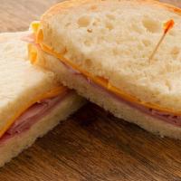 (Kids) Smoked Ham & Cheddar · Served on our thin-sliced Honey White Bread with Mayonnaise, Smoked Ham, Cheddar Cheese.