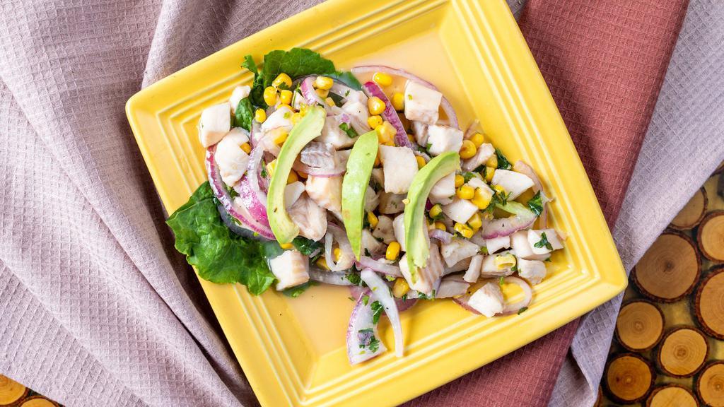 Tradicional Ceviche · Tilapia cooked in fresh lime juice, red onions, corn, cilantro, oregano salt, pepper, and olive oil.