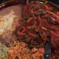 Steak Ranchero · Flank steak cooked with bell peppers, onions, jalapenos, and our special red sauce. Served w...
