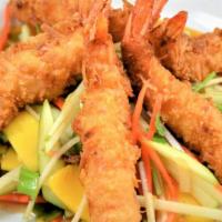 Coconut Shrimp: · Golden-fried coconut shrimp on a bed of fruit salad tossed with lime sauce.