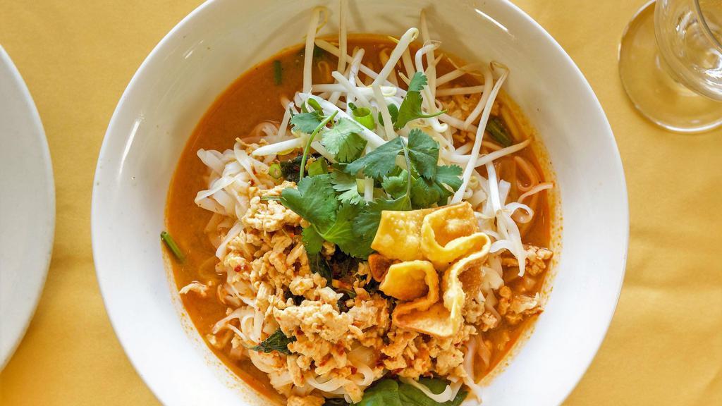 Spicy Coconut Noodles:* · Rice noodles in spicy coconut milk soup w/minced chicken, bean sprouts, and fresh basil, topped with a crispy fried wonton, crushed peanuts, green onion, and cilantro.