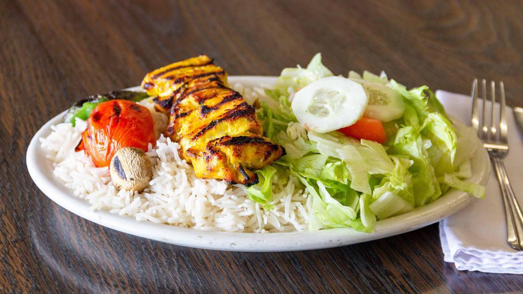 Chicken Kebab Plate · Marinated skinless and boneless chicken breast pieces skewered and grilled to order. Served with rice and salad.