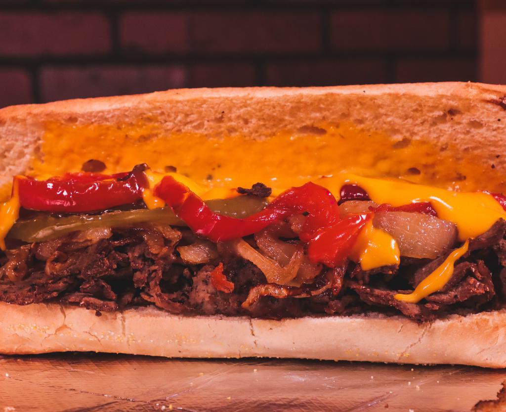 Sweet Pepper Cheesesteak · Sliced ribeye steak, melted nacho cheese, grilled onions, roasted peppers, on a hoagie roll.