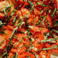 El Egante · Basil chèvre, fresh tomato and roasted garlic. Topped with fresh basil. Contains: soy and ca...