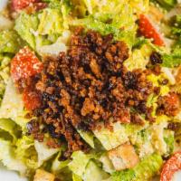 Caesar · Romaine lettuce, bacon, tomatoes, croutons, almond parmesan with caesar dressing