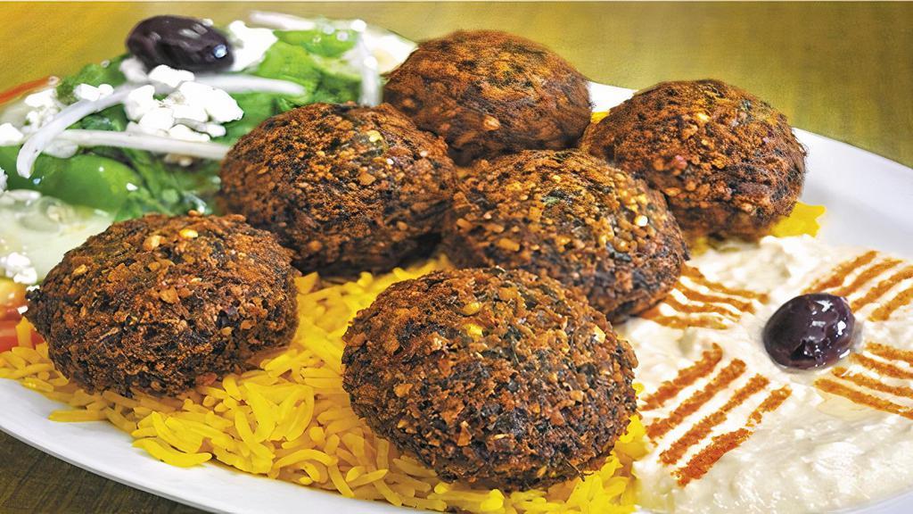 Falafel Plate  · Vegan. Seasoned ground chick peas, fava beans, and sesame seed deep fried to crispness, served with hummus, salad, rice, pita, and sauce